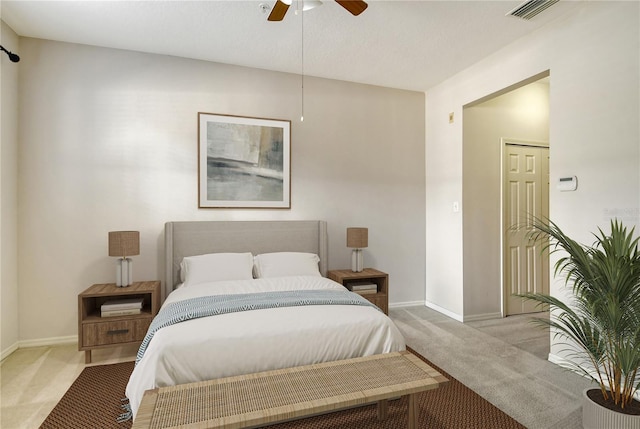 carpeted bedroom with baseboards, visible vents, and ceiling fan