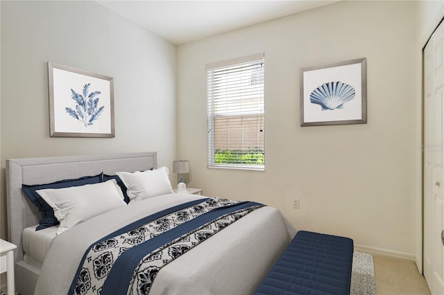 bedroom featuring carpet floors and baseboards