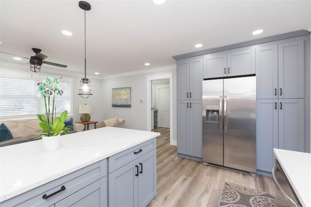 kitchen featuring gray cabinets, appliances with stainless steel finishes, decorative light fixtures, ornamental molding, and light hardwood / wood-style flooring