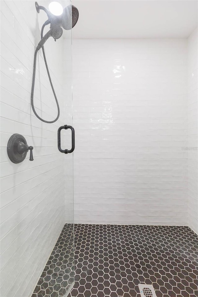 bathroom with a shower with shower door