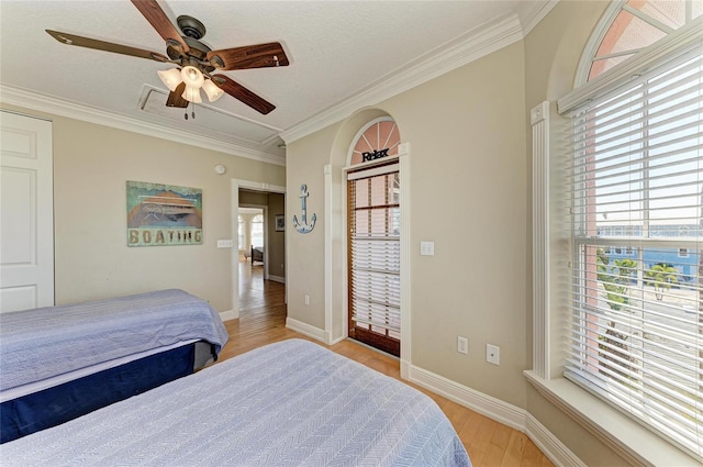 bedroom with ornamental molding, ceiling fan, and light wood-type flooring