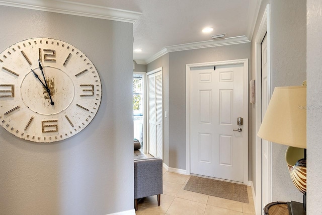 entrance foyer with light tile patterned floors and ornamental molding