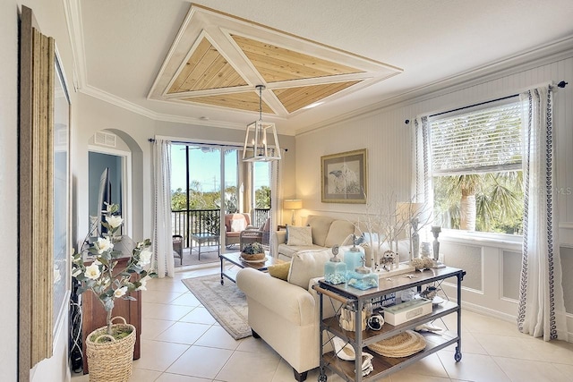 tiled living room featuring ornamental molding and a healthy amount of sunlight