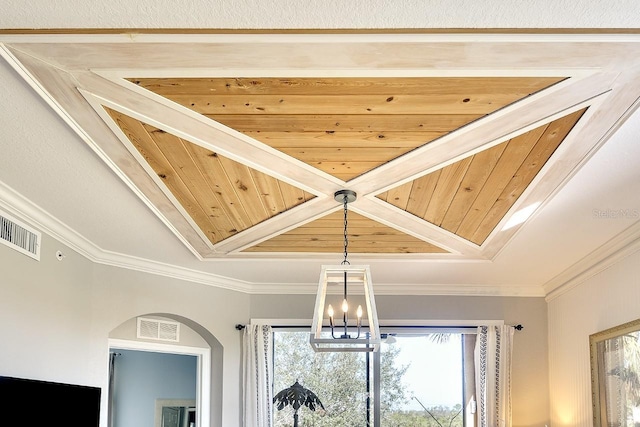 interior details featuring crown molding and a chandelier