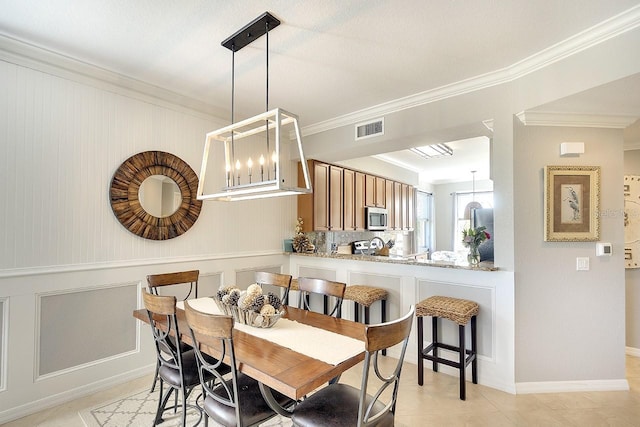 dining room featuring ornamental molding