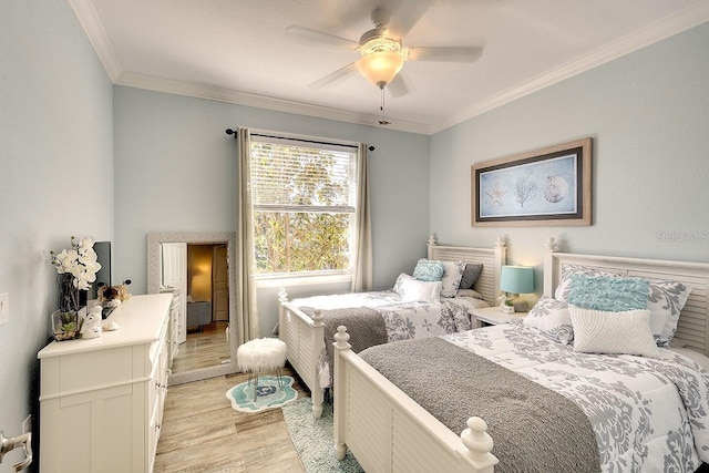 bedroom with ornamental molding, ceiling fan, and light hardwood / wood-style flooring