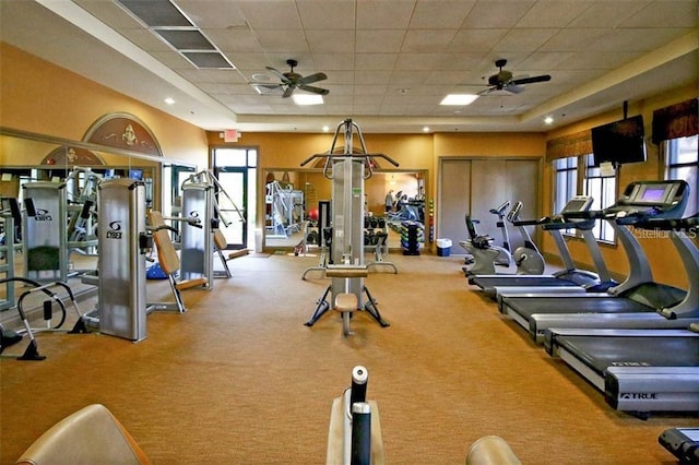 workout area with light carpet, a drop ceiling, and ceiling fan