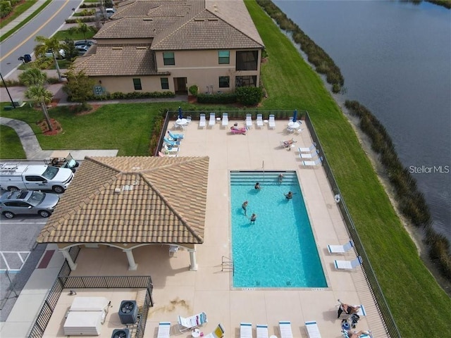 view of pool featuring a water view and a patio area