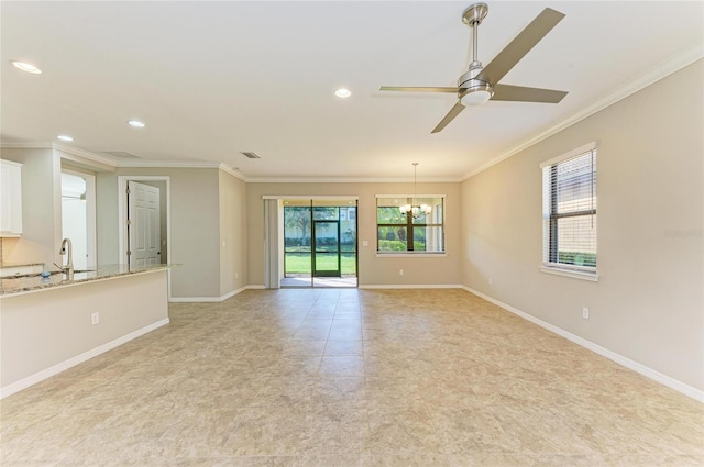 empty room featuring crown molding, ceiling fan with notable chandelier, and a healthy amount of sunlight