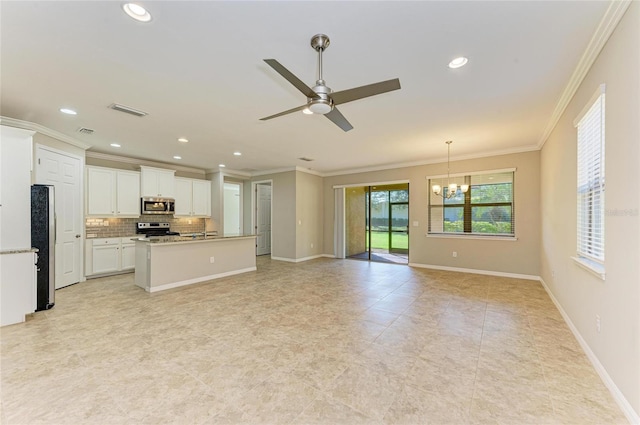 kitchen with appliances with stainless steel finishes, white cabinetry, an island with sink, backsplash, and ornamental molding