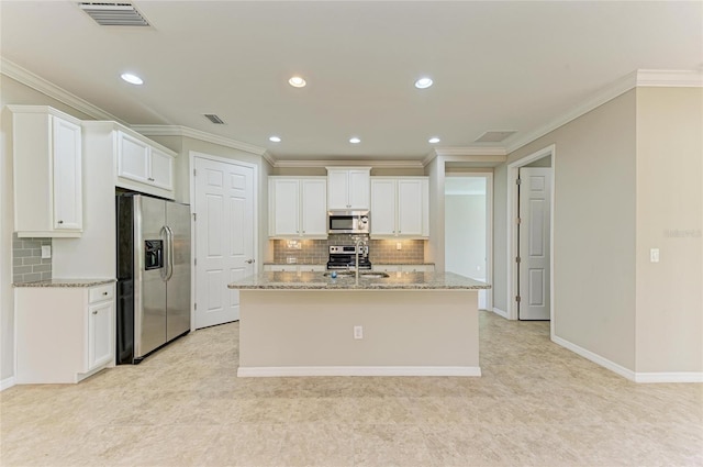 kitchen with sink, a kitchen island with sink, stainless steel appliances, light stone counters, and white cabinets