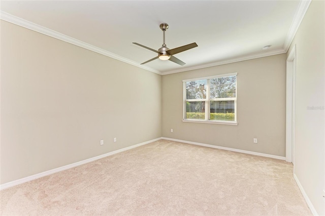 carpeted spare room featuring ceiling fan and ornamental molding