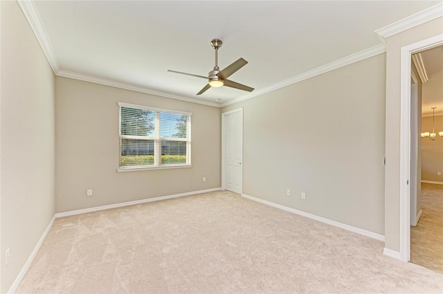 unfurnished room featuring light colored carpet, ceiling fan with notable chandelier, and ornamental molding