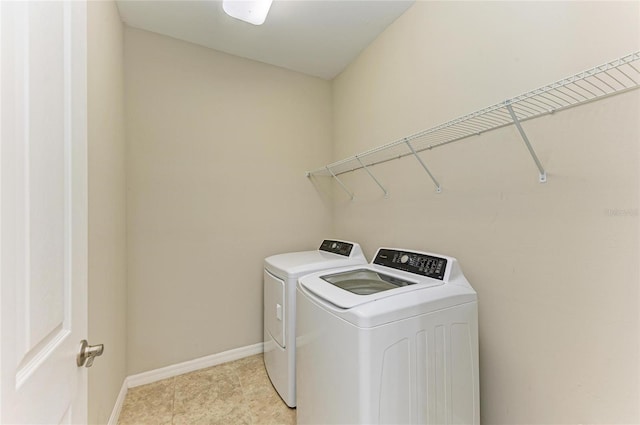 clothes washing area featuring independent washer and dryer