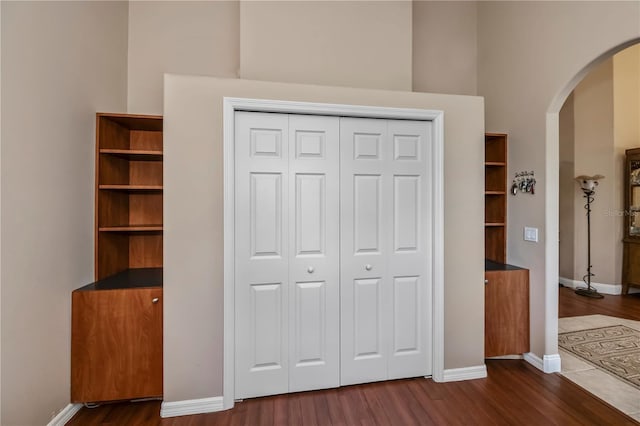 unfurnished bedroom featuring a closet and dark hardwood / wood-style floors