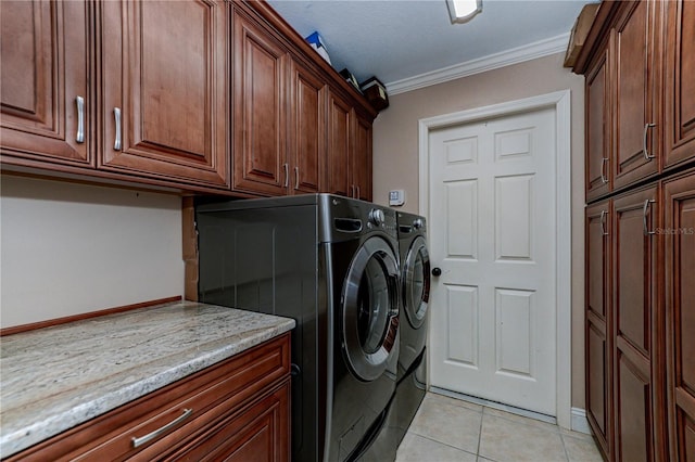 laundry room with cabinets, crown molding, light tile patterned floors, and independent washer and dryer