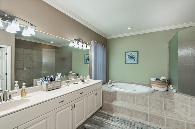 bathroom with tiled tub, ornamental molding, vanity, and tile patterned floors