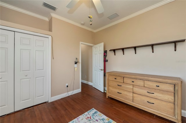 unfurnished bedroom featuring a closet, ornamental molding, dark hardwood / wood-style floors, and ceiling fan