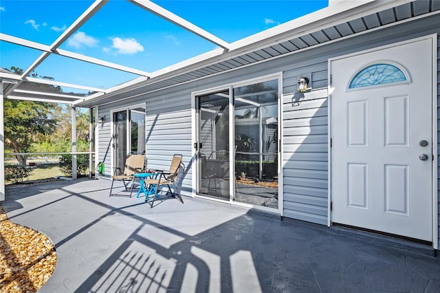 view of patio featuring glass enclosure