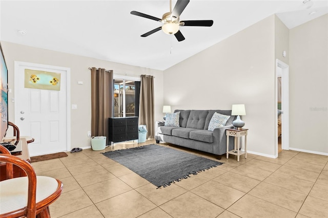 living room featuring lofted ceiling, light tile patterned floors, and ceiling fan