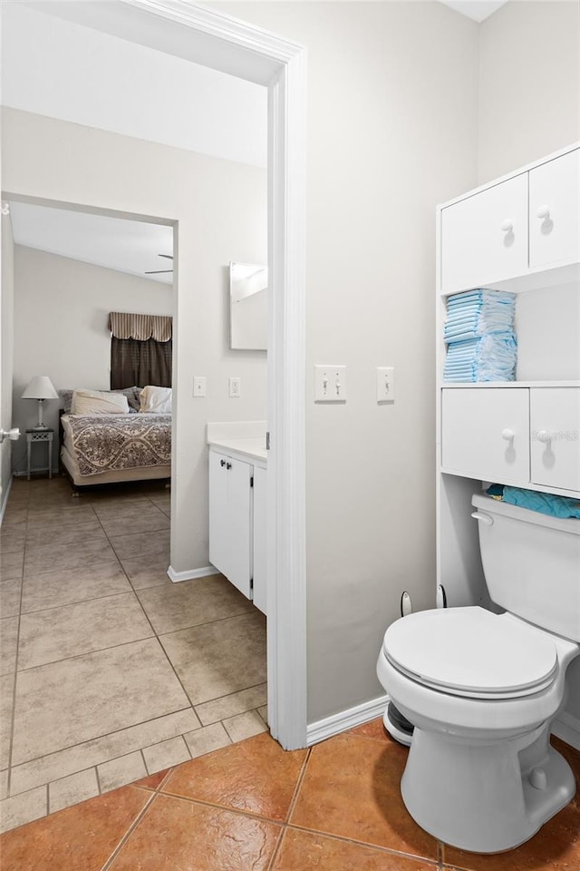 bathroom with tile patterned flooring, vanity, and toilet