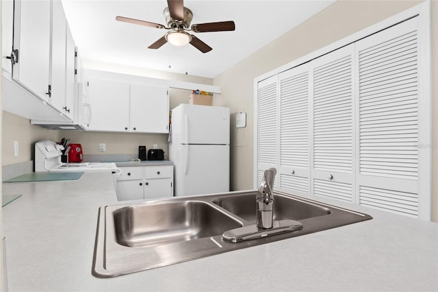 kitchen with white cabinetry, sink, ceiling fan, and white appliances