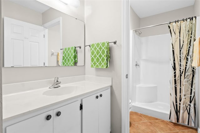 bathroom featuring walk in shower, tile patterned floors, and vanity