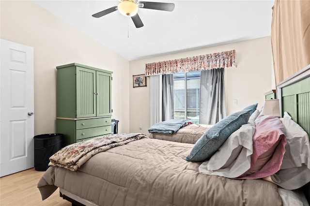 bedroom featuring vaulted ceiling, access to exterior, ceiling fan, and light hardwood / wood-style floors