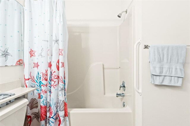 bathroom with shower / bath combo and toilet