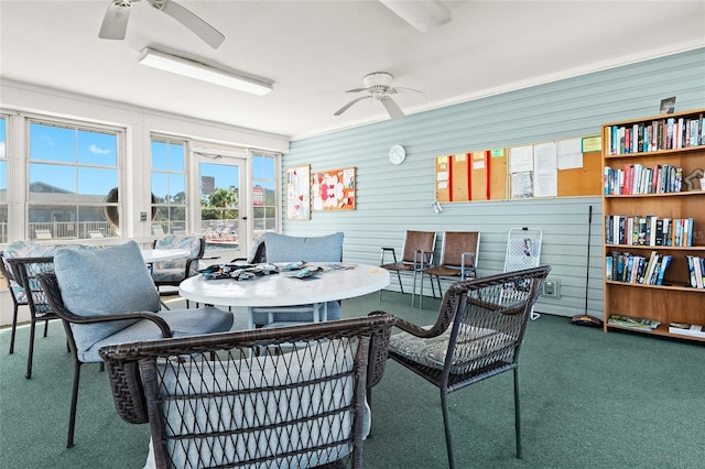 sunroom featuring ceiling fan