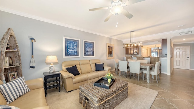 living room with crown molding, ceiling fan with notable chandelier, and light tile patterned flooring