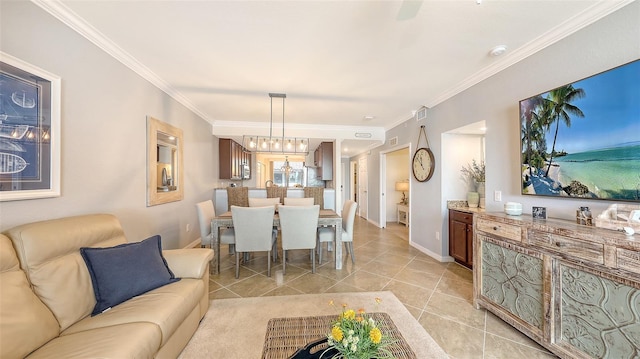 tiled living room featuring crown molding and a notable chandelier