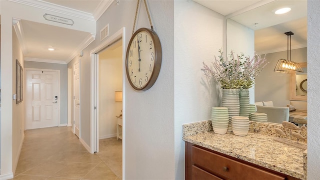 hall featuring ornamental molding and light tile patterned floors