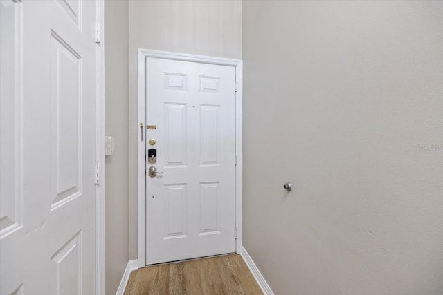 doorway with light wood-type flooring