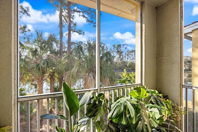 unfurnished sunroom with a water view