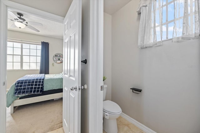 bathroom with a textured ceiling, ceiling fan, and toilet