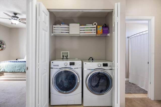 laundry room with light carpet, ceiling fan, and washing machine and clothes dryer