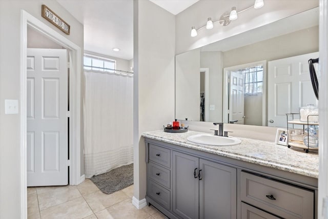 bathroom with vanity, tile patterned flooring, and curtained shower