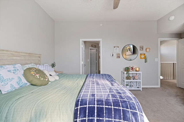 bedroom with ceiling fan, carpet, and a textured ceiling