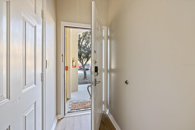 hallway with light hardwood / wood-style flooring