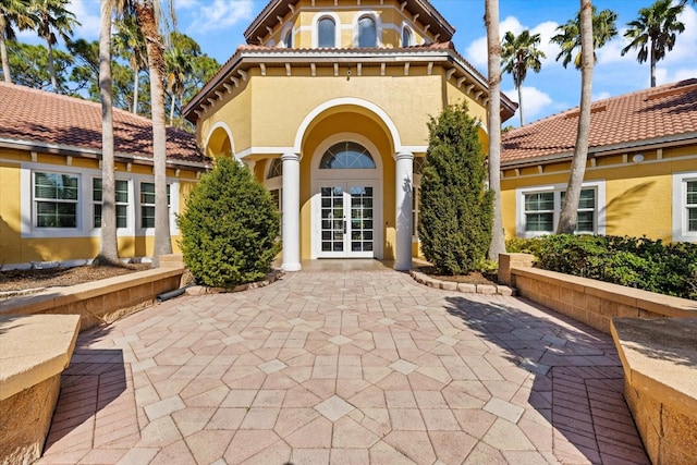 doorway to property with a patio area and french doors