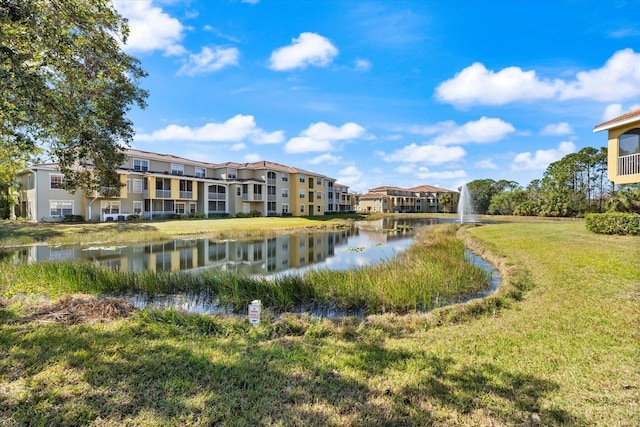 surrounding community featuring a yard and a water view