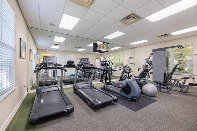 exercise room with a paneled ceiling