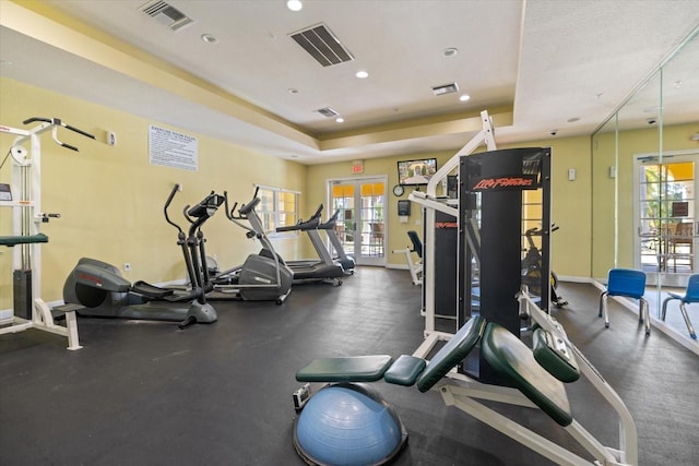 workout area featuring a tray ceiling