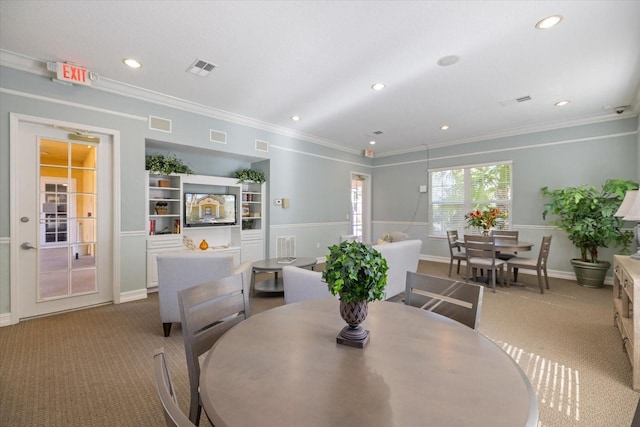 dining area with carpet floors and ornamental molding