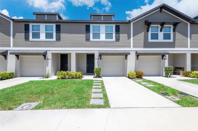 17136 Blowfish Dr, Nokomis, FL 34275 - townhome / multi-family property with an attached garage, a front lawn, stucco siding, and driveway