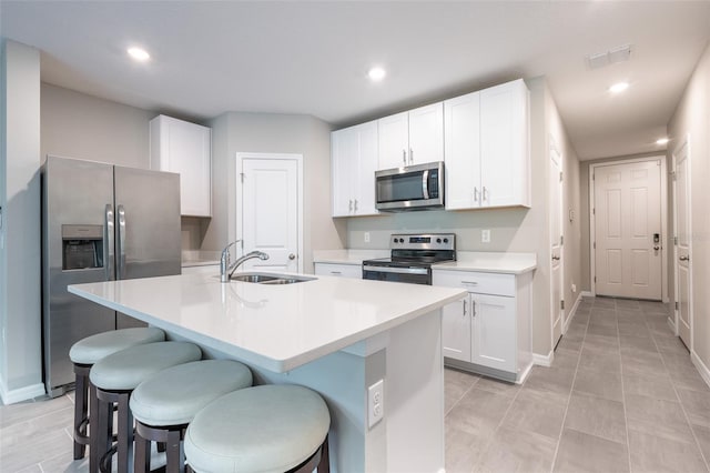 17136 Blowfish Dr, Nokomis, FL 34275 - kitchen with appliances with stainless steel finishes, a kitchen breakfast bar, light countertops, white cabinetry, and recessed lighting