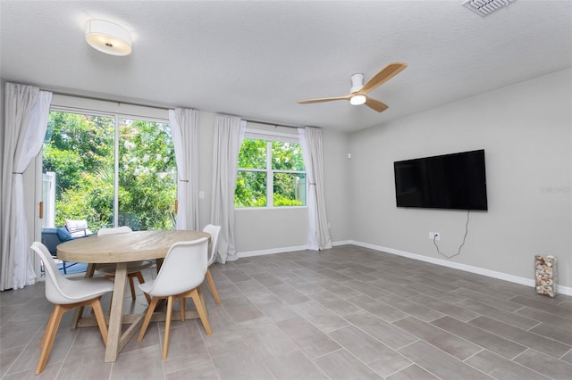 17136 Blowfish Dr, Nokomis, FL 34275 - dining space featuring a ceiling fan and a textured ceiling