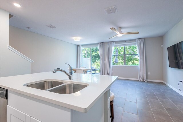 17136 Blowfish Dr, Nokomis, FL 34275 - kitchen featuring light countertops, white cabinetry, a ceiling fan, tile patterned floors, and recessed lighting
