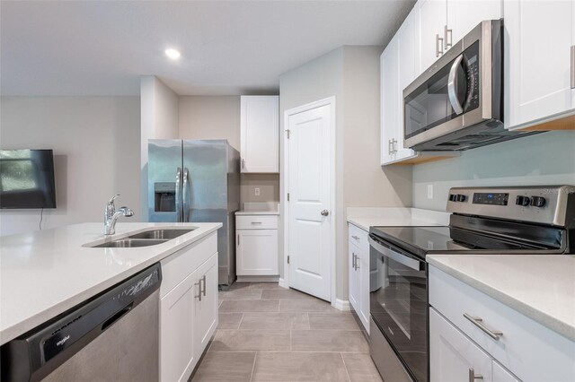 17136 Blowfish Dr, Nokomis, FL 34275 - kitchen with stainless steel appliances, white cabinets, light countertops, and recessed lighting